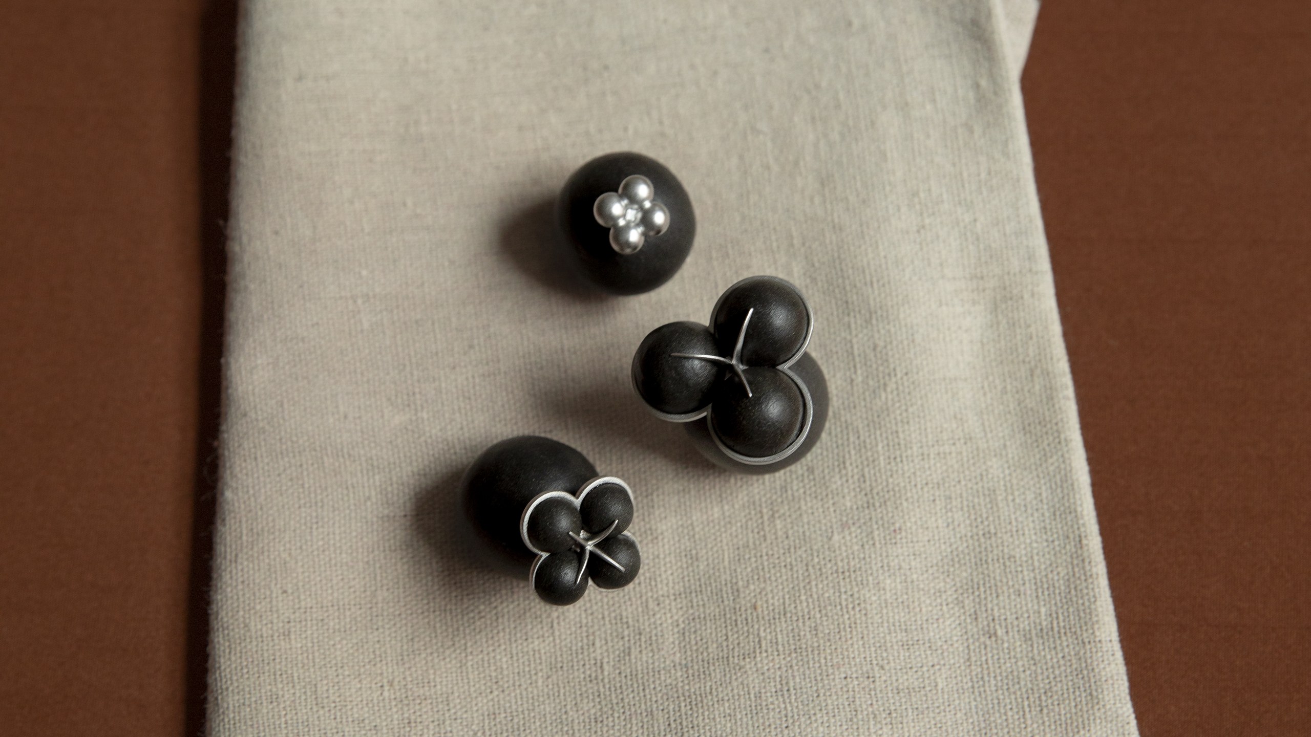 Hills Between 2025 FW collection — black incense-bead jewellery on linen